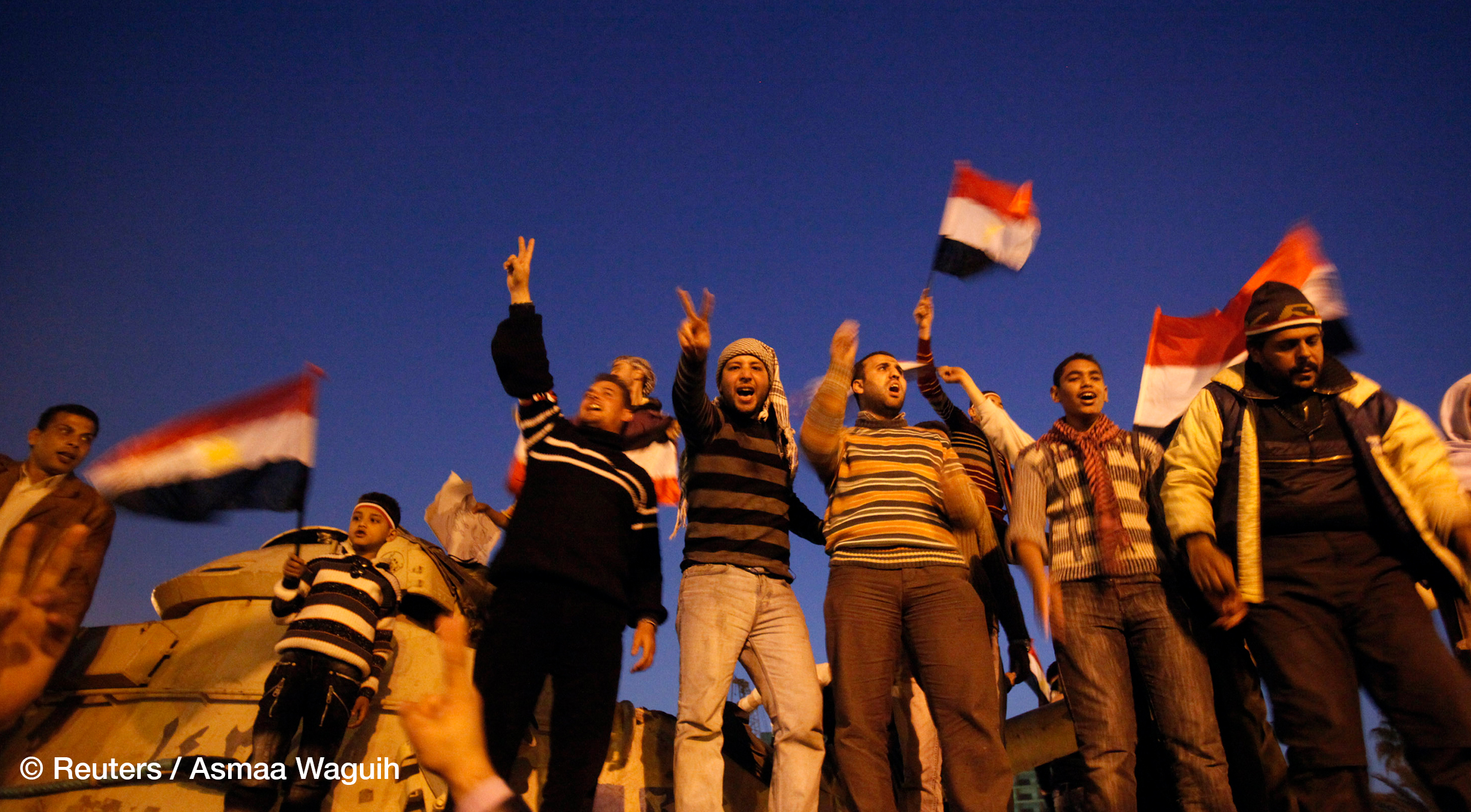 Anti-government protesters celebrate inside Tahrir Square after the announcement of Egyptian President Hosni Mubarak's resignation in Cairo February 11, 2011.