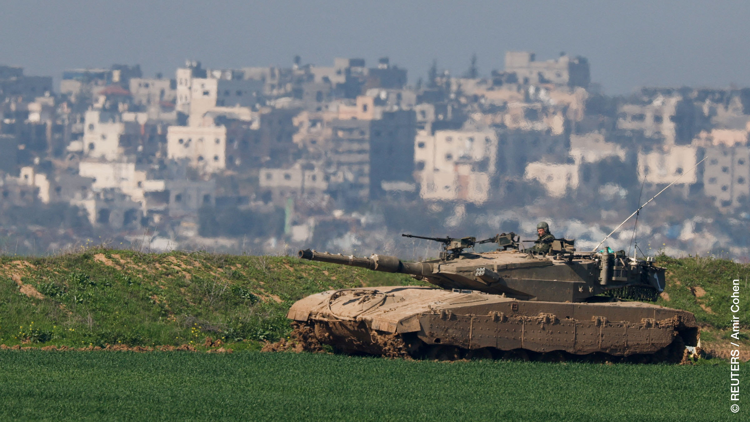 An Israeli tank manoeuvres along the northern Gaza Strip border.